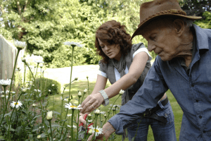 helping older gentleman at home with gardening